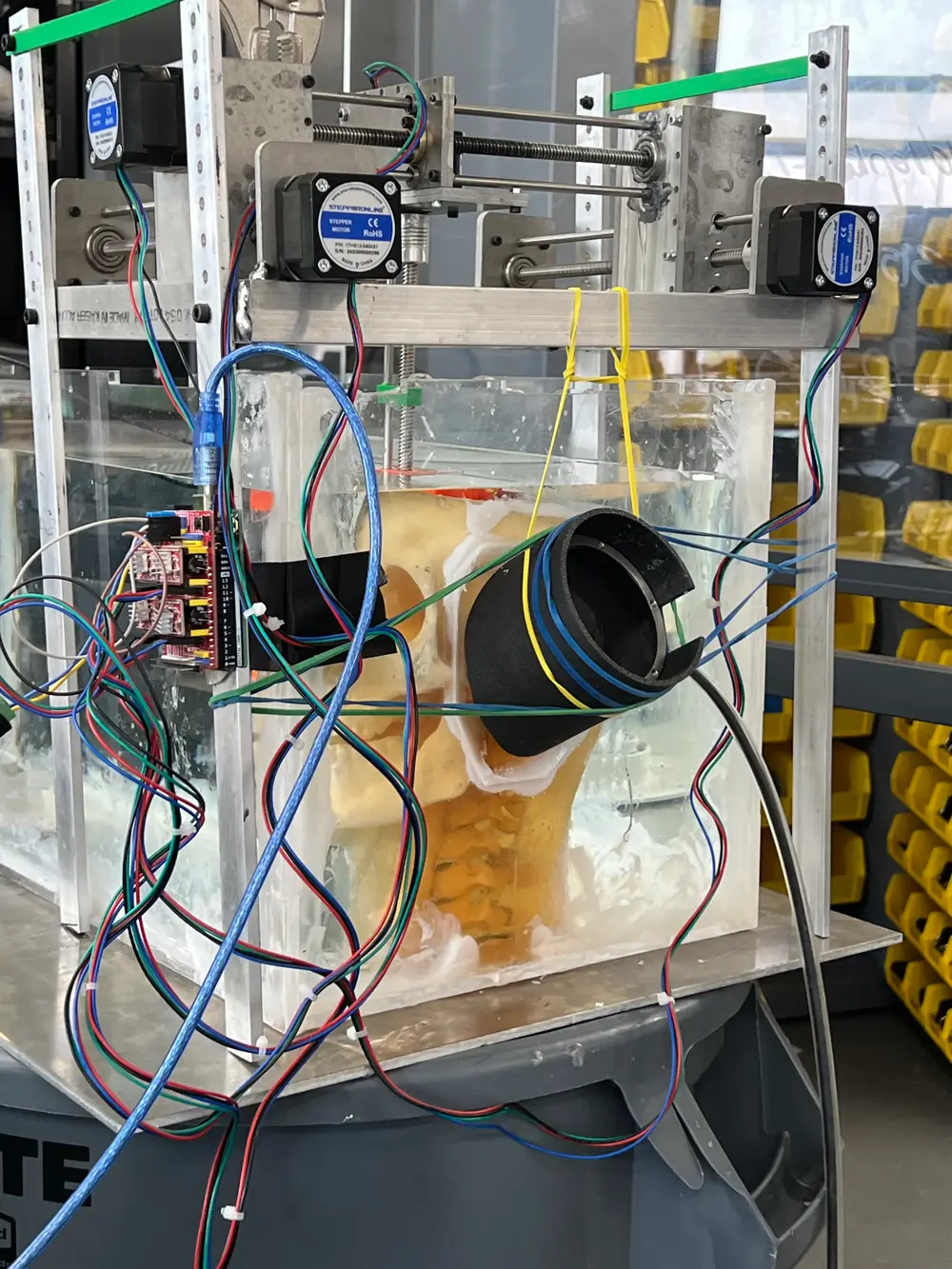 Motorized gantry rig positioning a probe over a tissue phantom